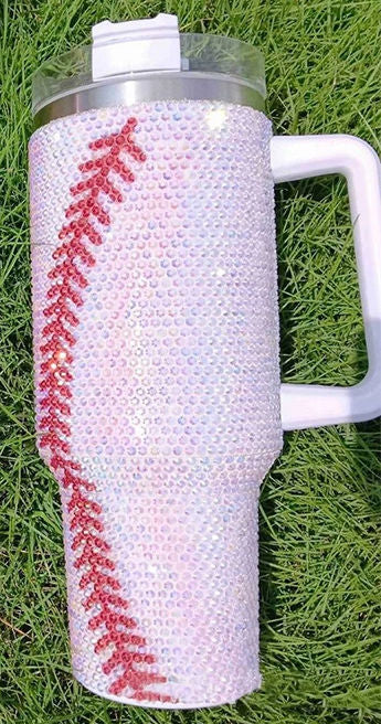 Tumbler with baseball design on grass