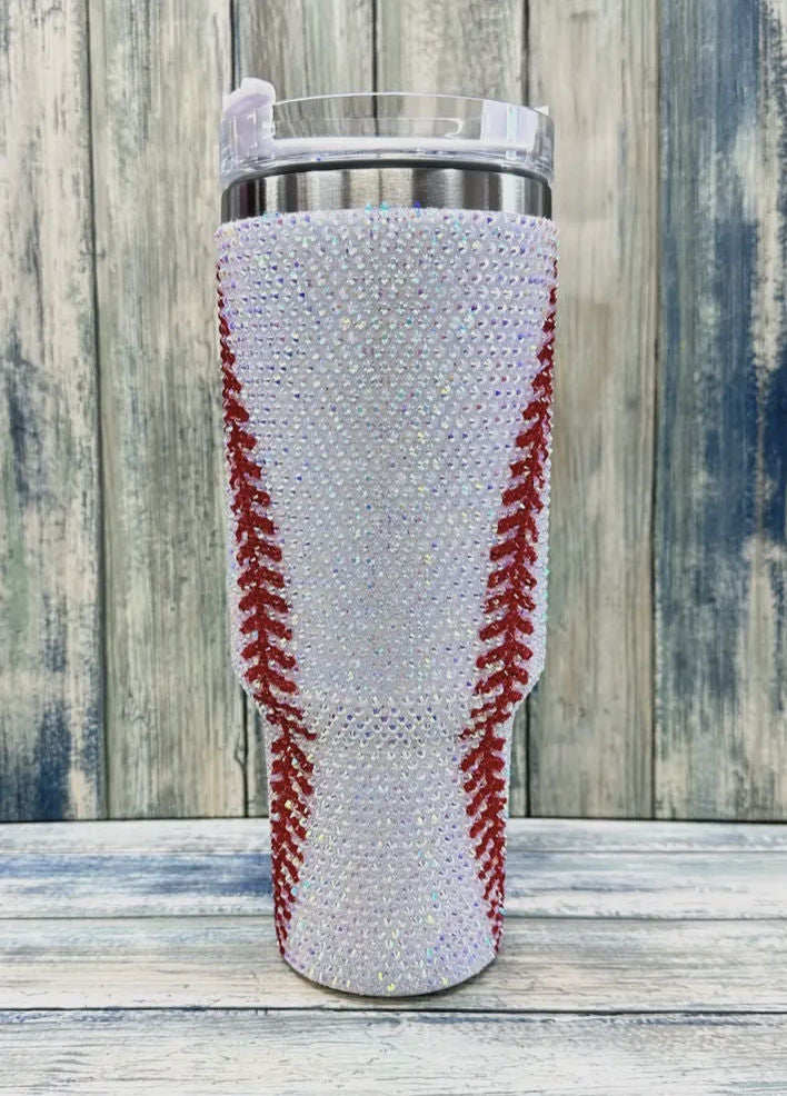 Tumbler with a baseball pattern on a wooden surface