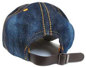 Blue denim cap with a leather strap on a white background