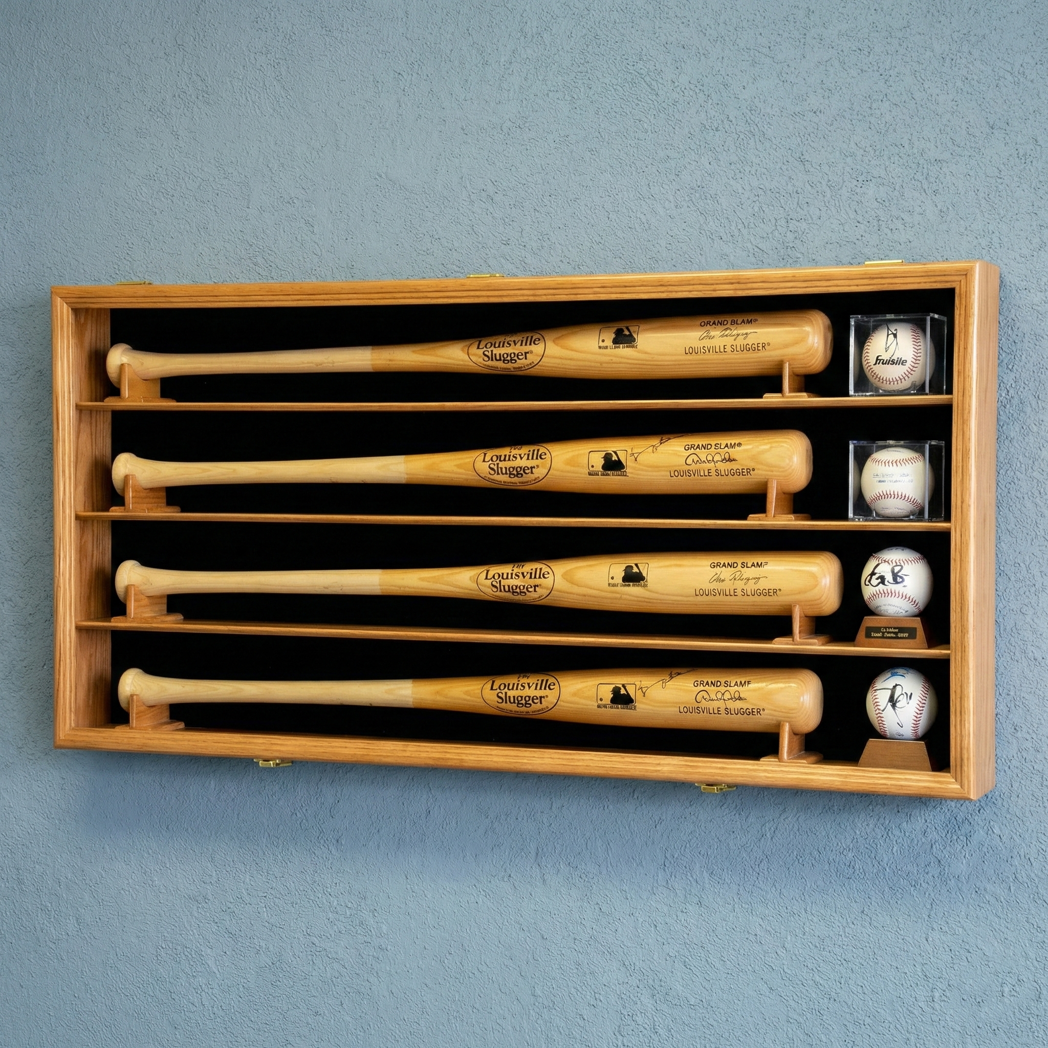 Wooden display case with baseball bats and balls on a blue wall