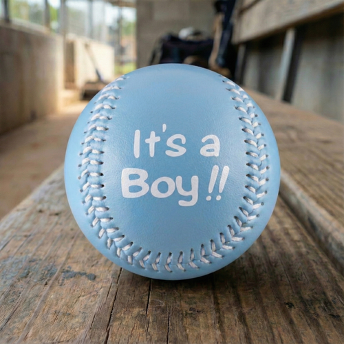 Blue baby baseball with 'It's a Boy!!' text on a wooden dugout bench