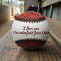 Baseball with 'I Love you to the centerfield fence & back' text on a wooden baseball dugout bench