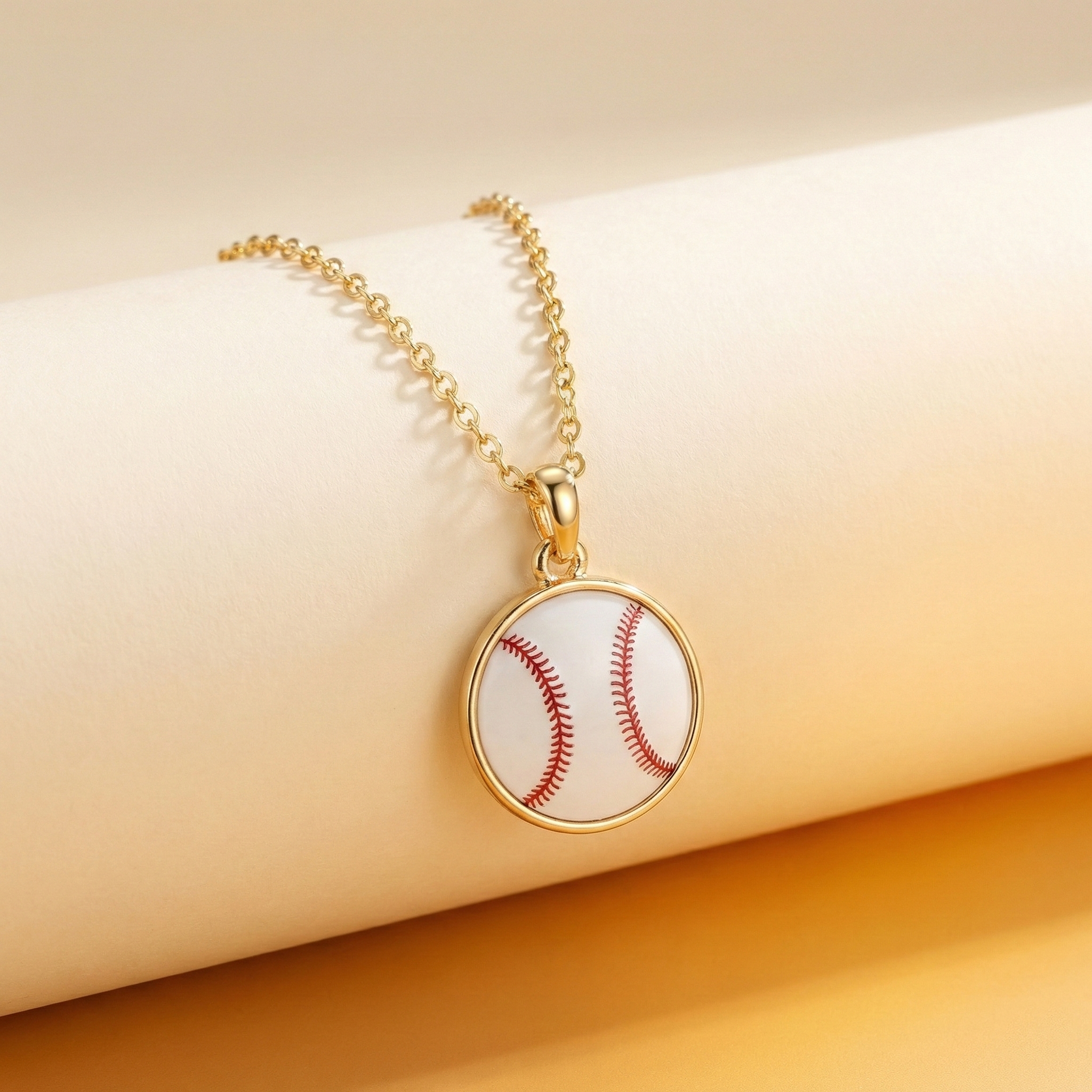 Necklace with a baseball pendant on a beige surface