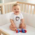 Baby boy in crib wearing Baseball Crawler and Sock Set 