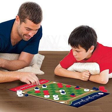 Man and child playing Boston Red Sox vs New York Yankees Rivalry Checkers Set on a wooden table.