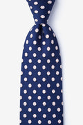 Navy blue tie with white polka dot pattern on a light blue background