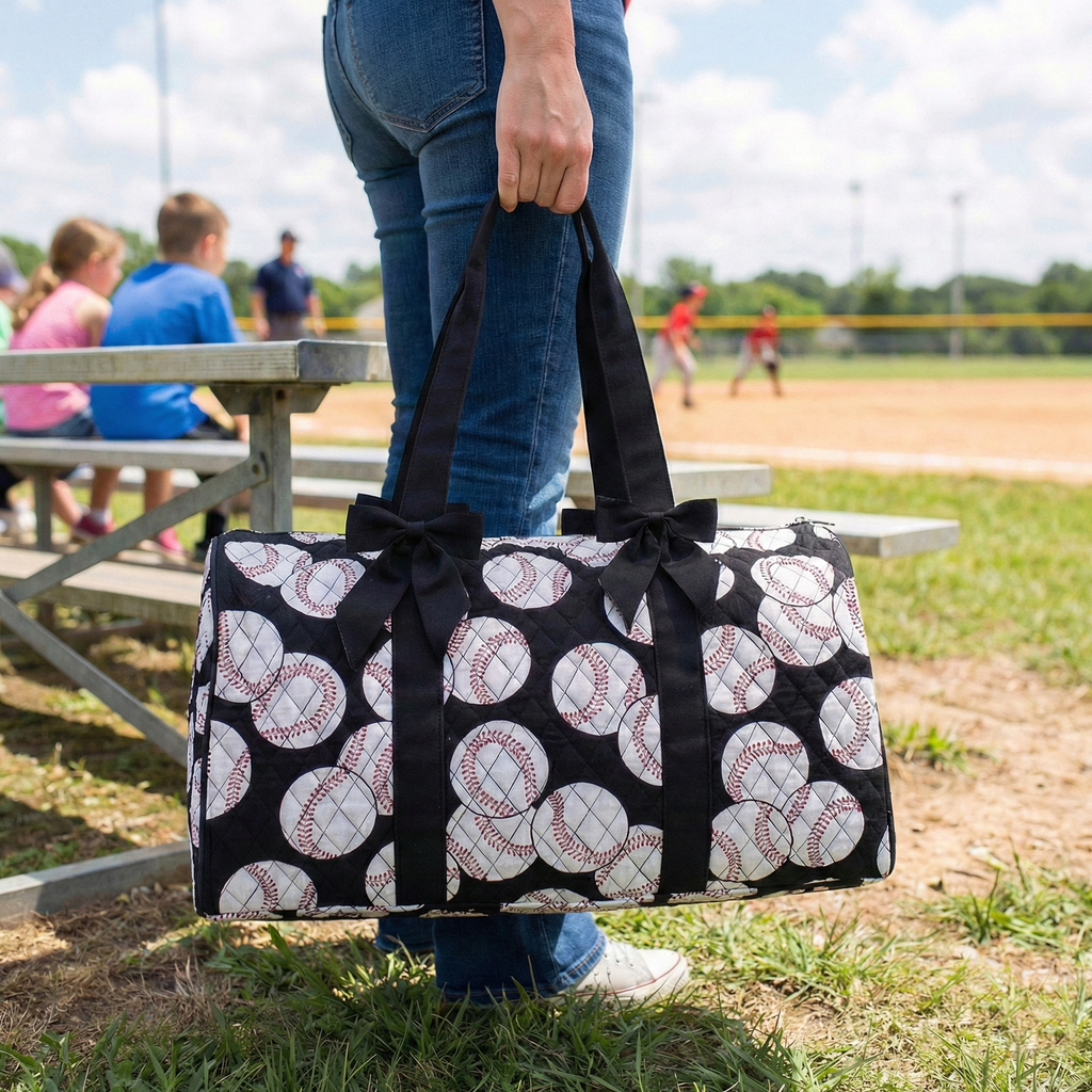 Person holding a black and white patterned bag at a baseball field