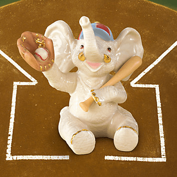 Elephant figurine with baseball bat and glove on a brown background