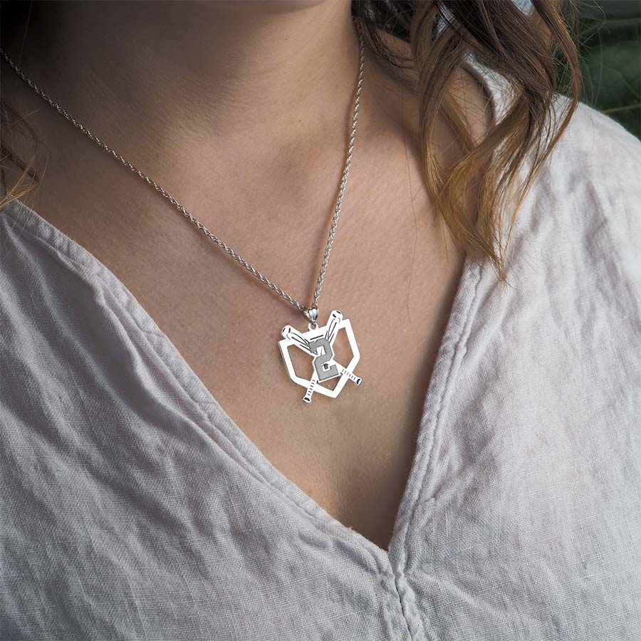 Custom baseball number silver necklace worn by a person in a light-colored shirt.