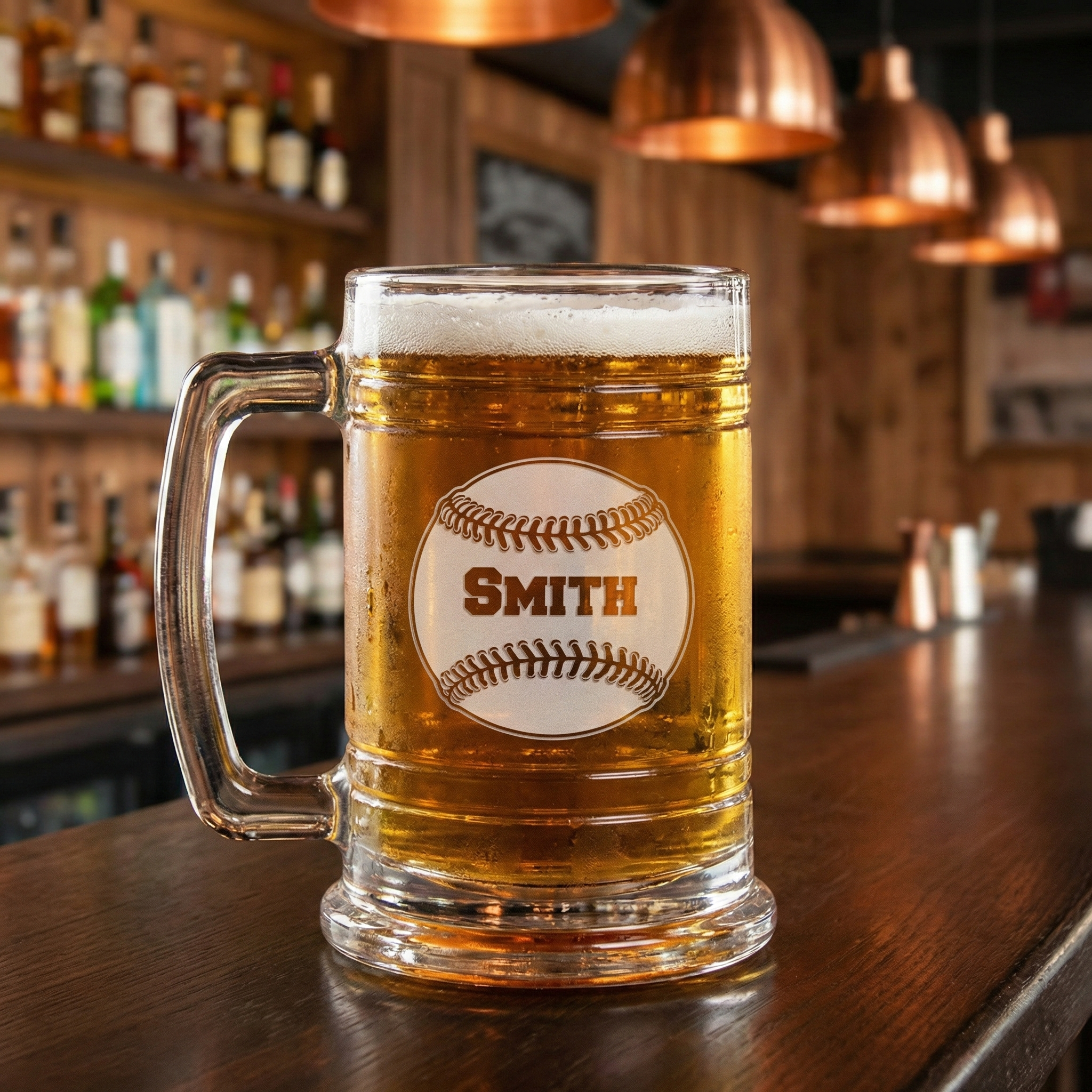 Custom baseball colonial tankard glass mug of cold beer with a 'Smith' etched baseball on a bar counter