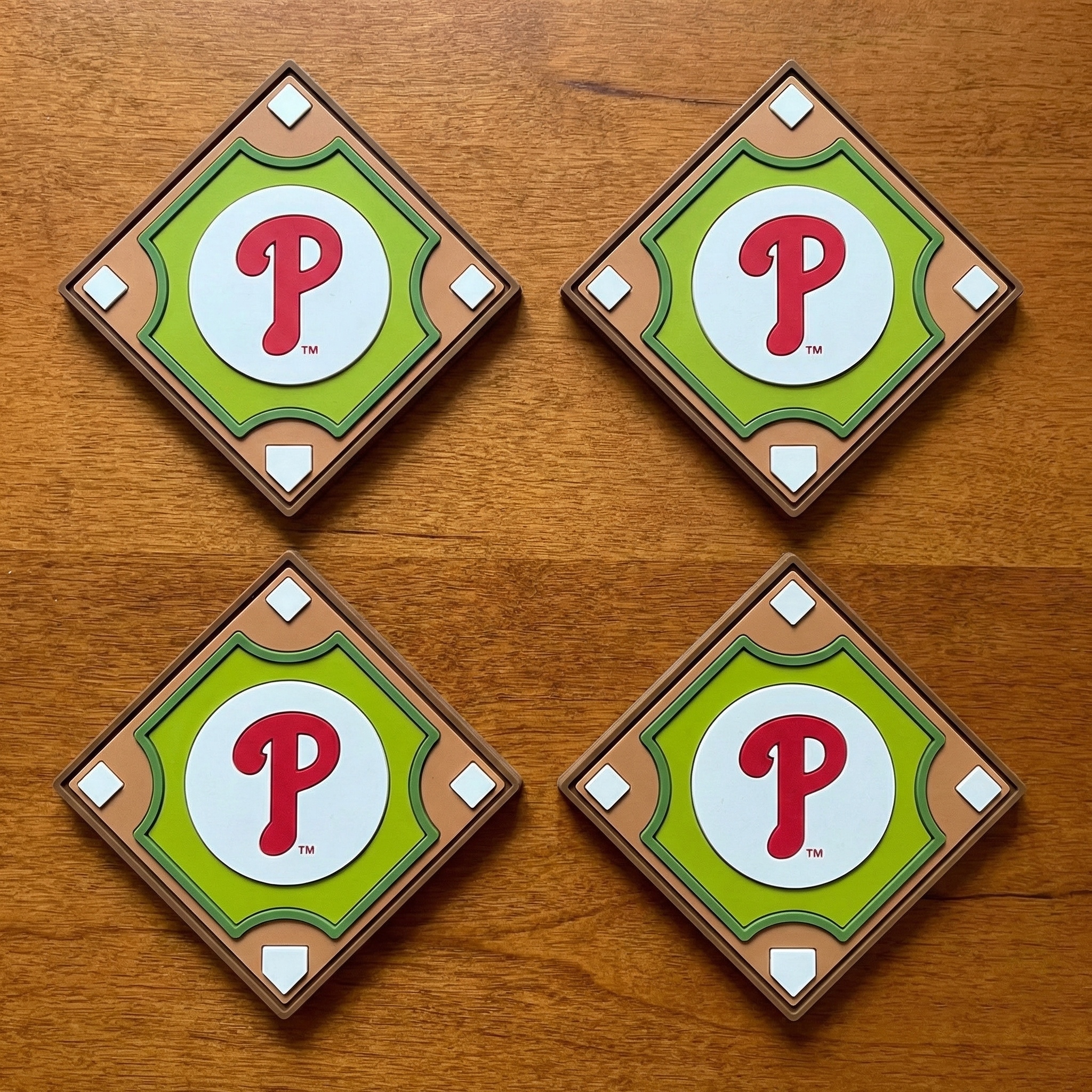 Four coaster set with a Phillies logo on a wooden surface