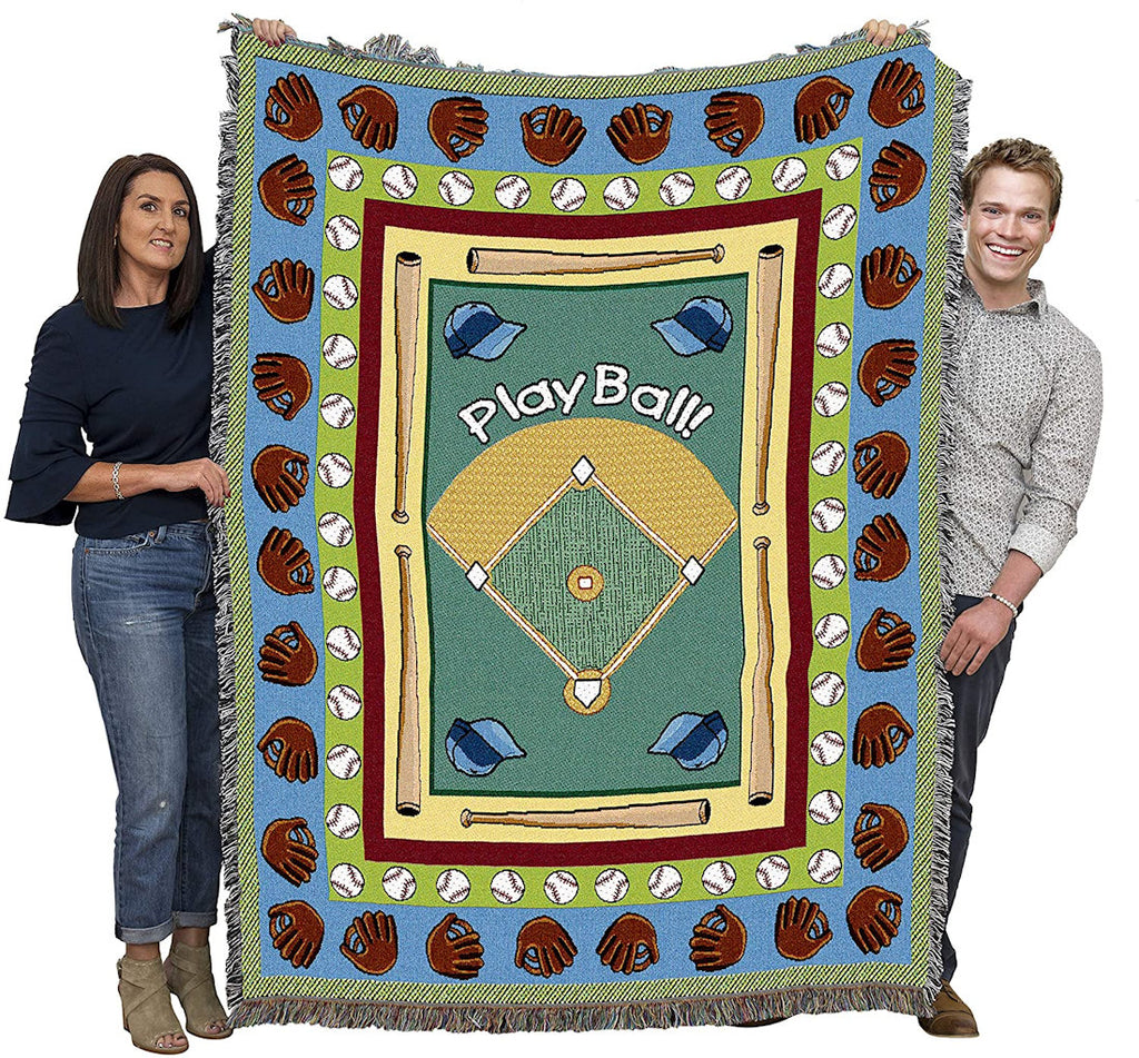Two people holding a baseball-themed tapestry throw blanket with 'Play Ball!' text and various baseball graphics.