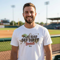 Man wearing a 'Play Hard, Get Dirty Baseball' t-shirt on a baseball field