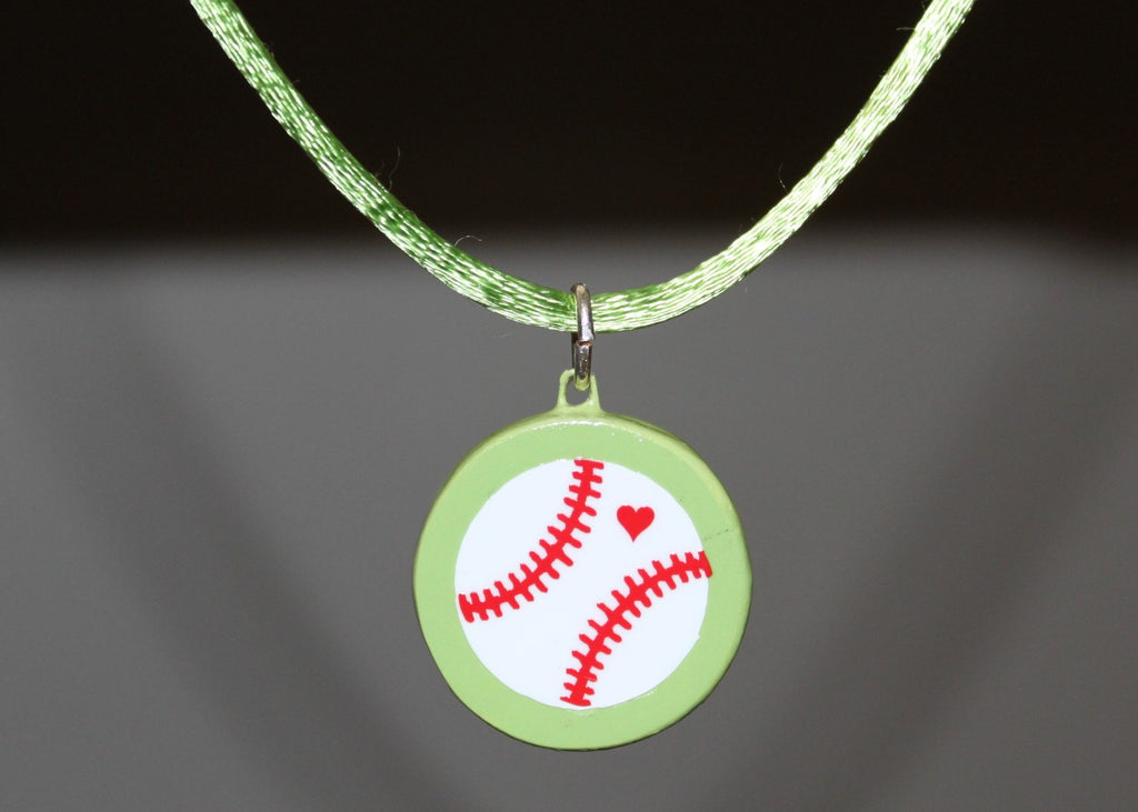 Lime green necklace with a pendant featuring a baseball design on a dark background