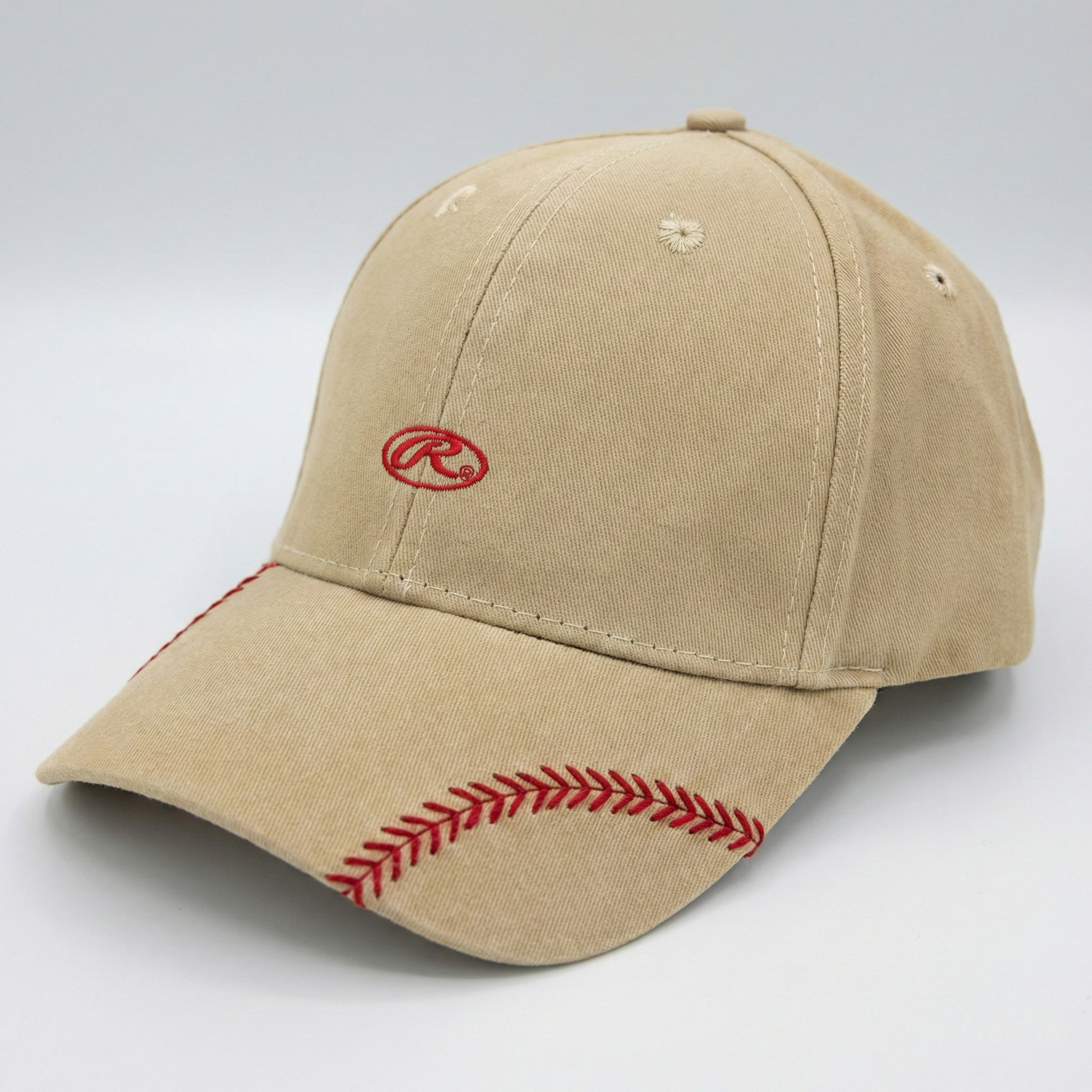 Beige Rawlings baseball cap with red stitching and logo on a light gray background
