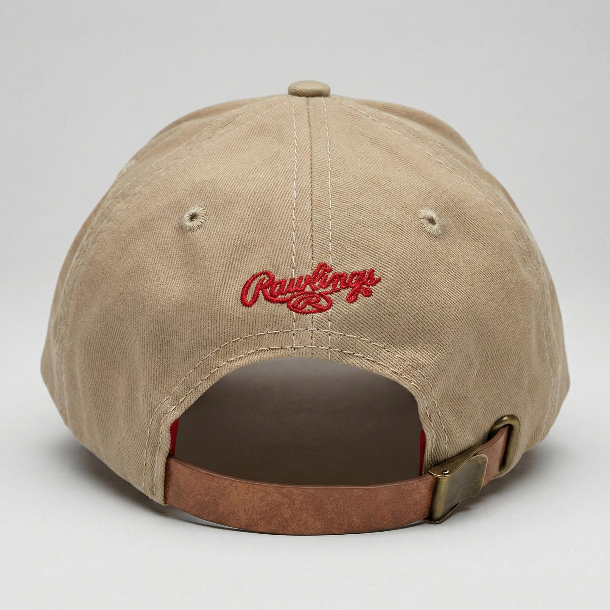 Beige baseball cap with red 'Rawlings' logo on a light gray background
