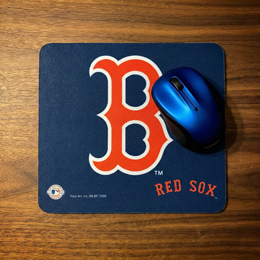 Blue mouse pad with red 'B' logo and 'Red Sox' text on a wooden surface