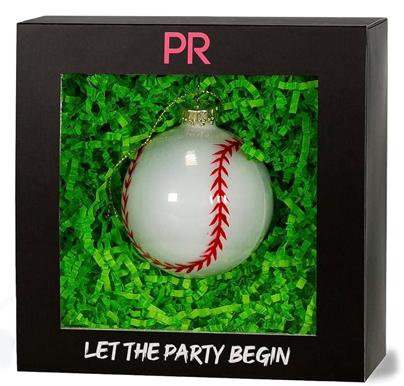 Decorative white baseball ornament in a black box with green grass.