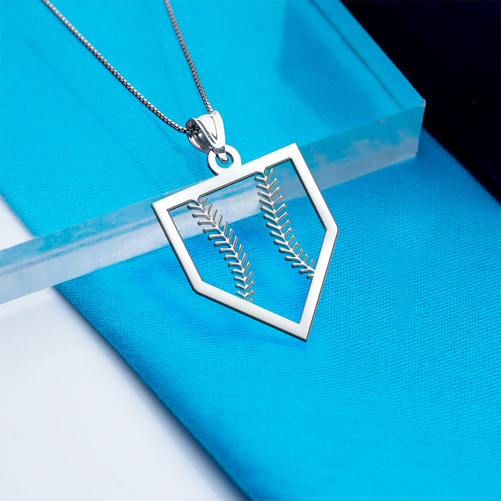 Silver pendant with leaf design on a blue background