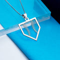 Silver pendant with leaf design on a blue background