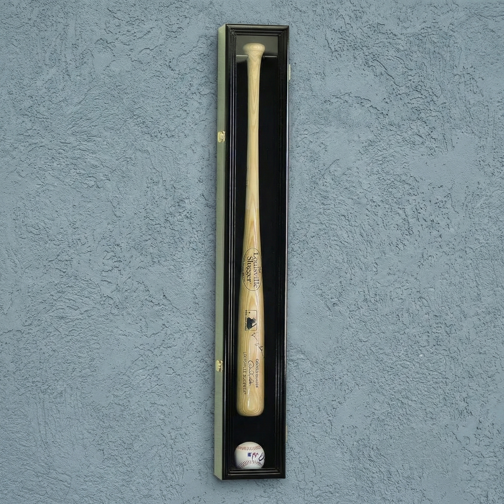 Baseball bat and ball in a display case against a textured blue wall