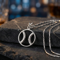 Sterling silver baseball zen necklace with a unique pendant on a dark stone surface