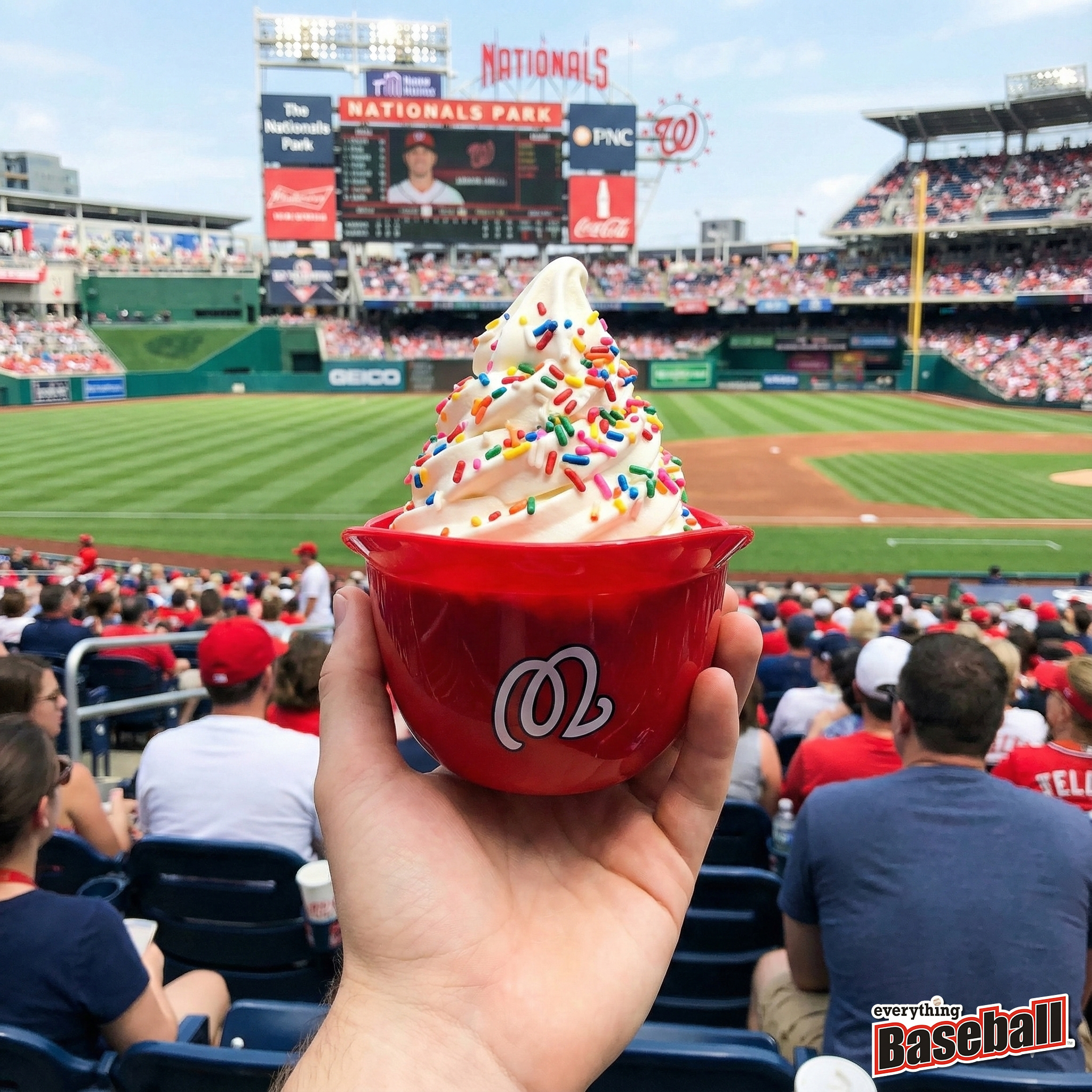 Hand holding a red cup with ice cream at a baseball game, Washington Nationals Park in the background