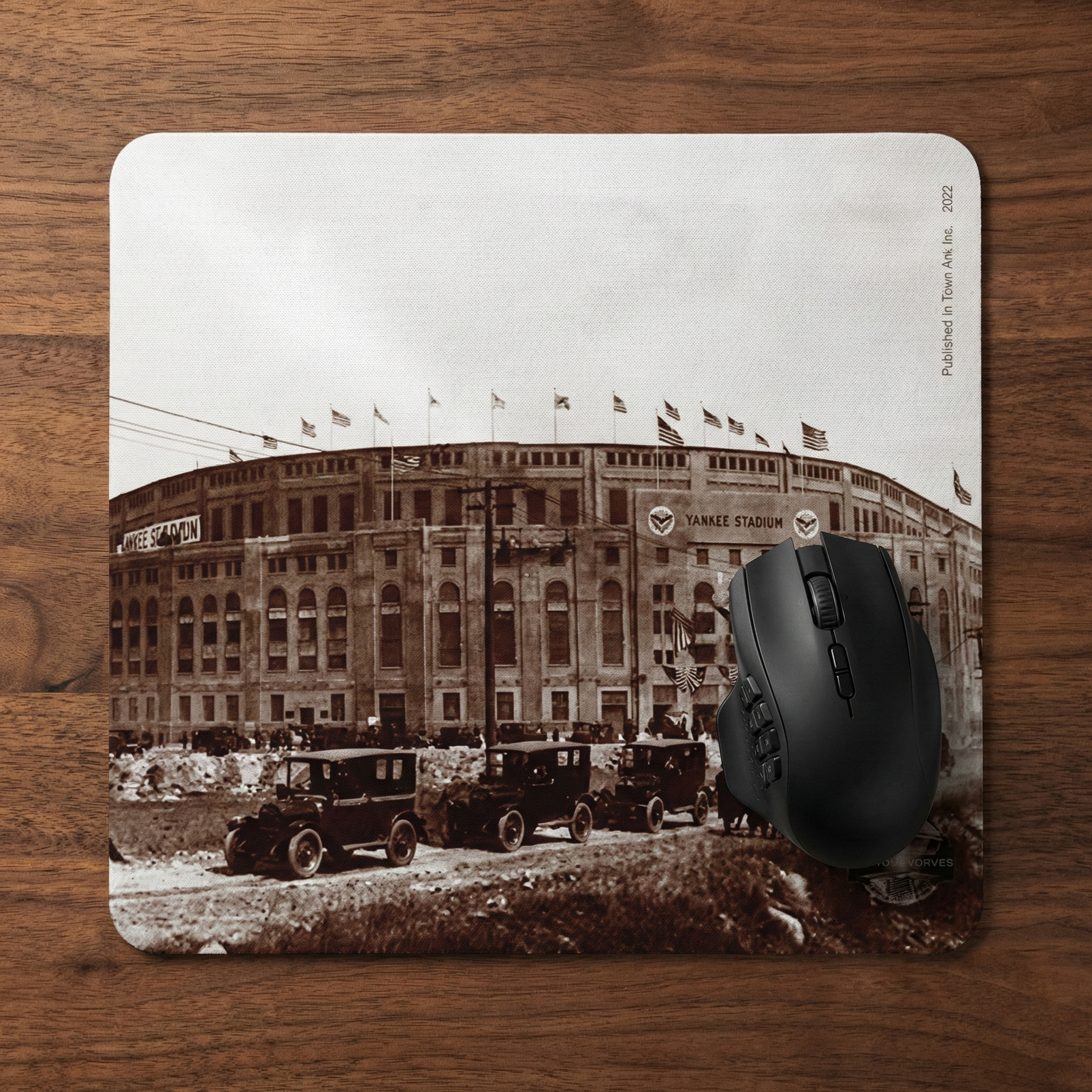 Mouse pad with vintage-style image of Yankee stadium and cars on a wooden surface